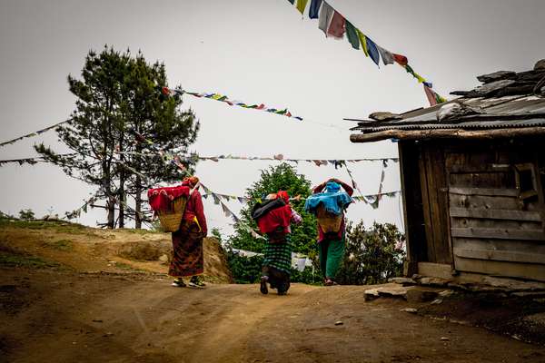Women carry goods back to their village, Nepal