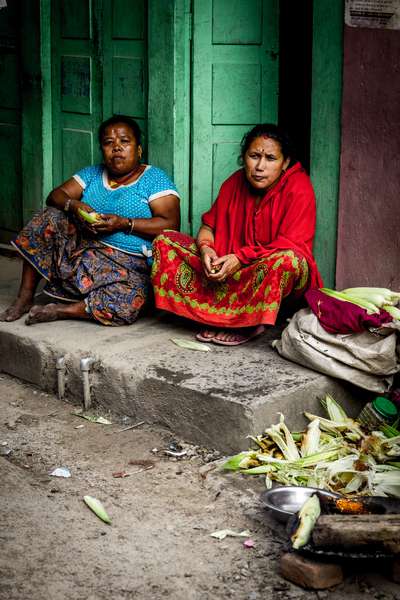 Women sit in a doorway in Kathmandu, Nepal